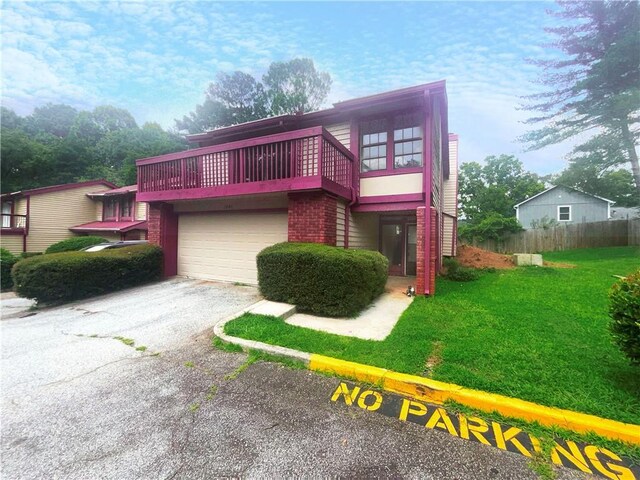 view of front of house with a garage and a front lawn