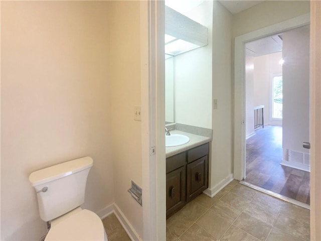 bathroom featuring vanity and toilet