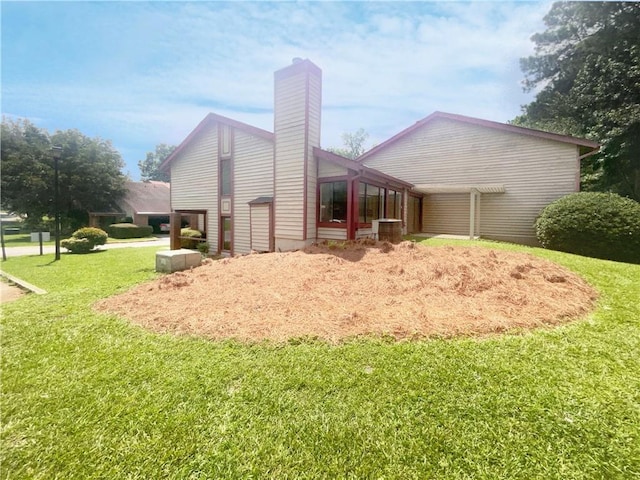 back of house with a lawn