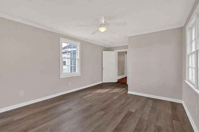 unfurnished room featuring crown molding, dark wood-style flooring, a ceiling fan, and baseboards