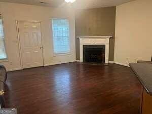 unfurnished living room featuring dark hardwood / wood-style flooring