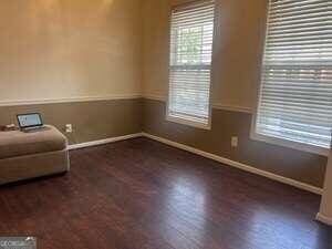 unfurnished room featuring dark hardwood / wood-style flooring