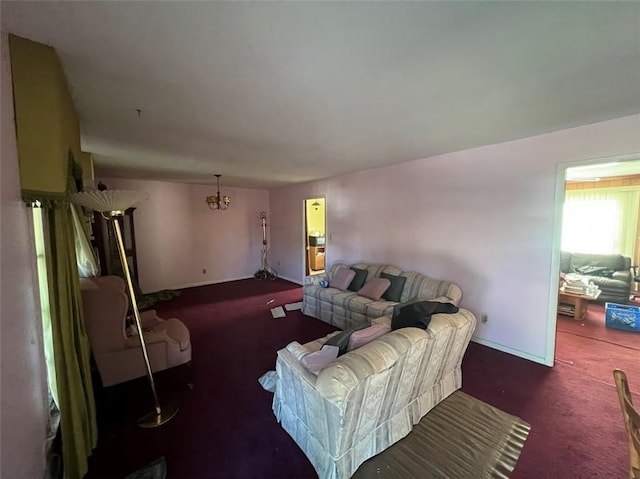 living room with a notable chandelier and dark carpet