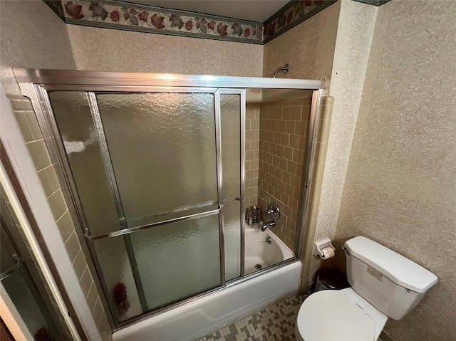 bathroom with enclosed tub / shower combo and toilet