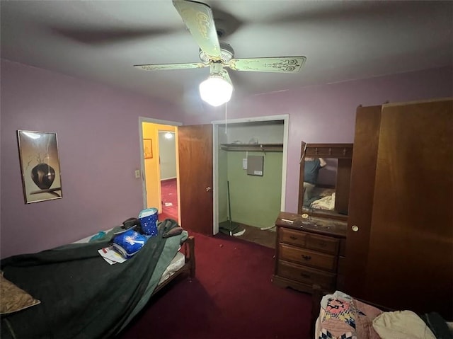 carpeted bedroom featuring ceiling fan and a closet