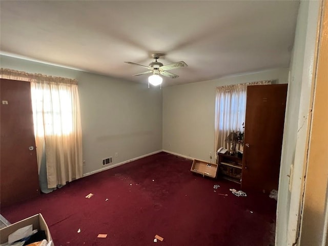 interior space with ceiling fan