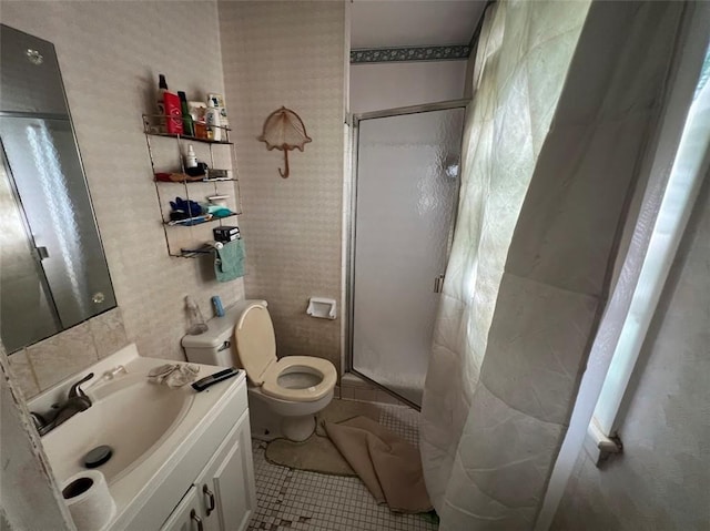 bathroom with an enclosed shower, vanity, tile patterned floors, and toilet