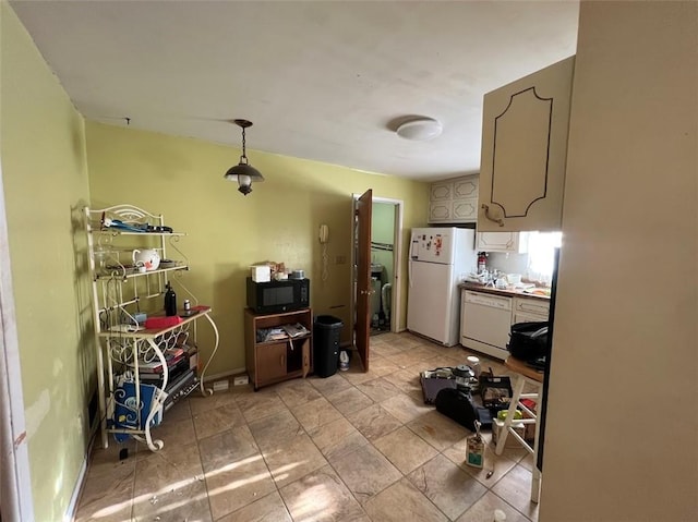 kitchen with white appliances and hanging light fixtures