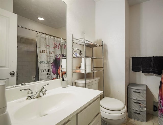 bathroom with a textured ceiling, curtained shower, tile patterned flooring, toilet, and vanity