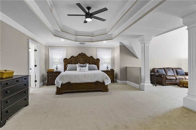 bedroom featuring a raised ceiling, ornamental molding, ornate columns, and light carpet