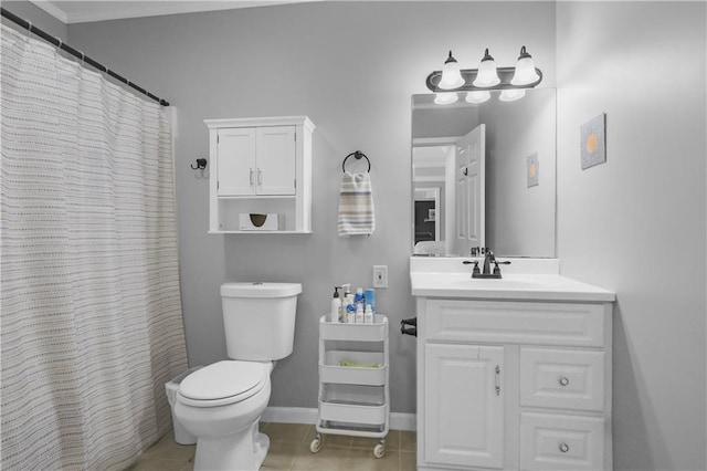 full bath featuring baseboards, toilet, vanity, and tile patterned flooring