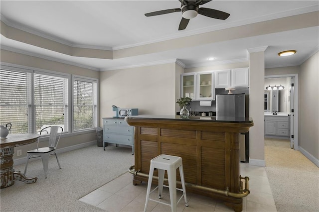 interior space featuring dark countertops, glass insert cabinets, white cabinets, fridge, and a ceiling fan