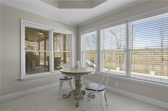 dining area featuring baseboards and crown molding