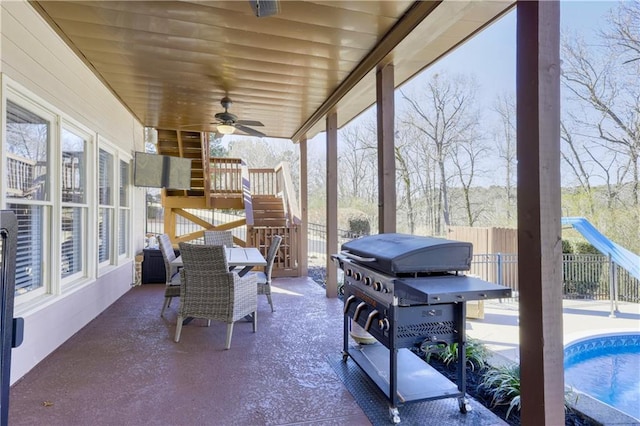 view of patio / terrace featuring a ceiling fan, fence, grilling area, stairway, and an outdoor pool