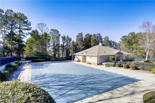 view of pool featuring fence