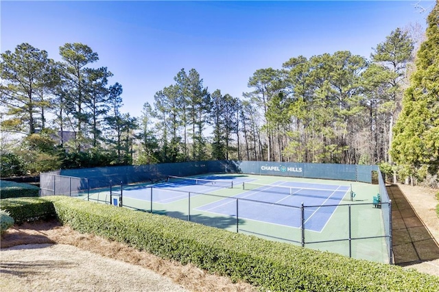 view of tennis court featuring fence