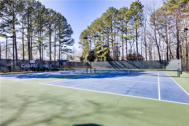 view of sport court with fence