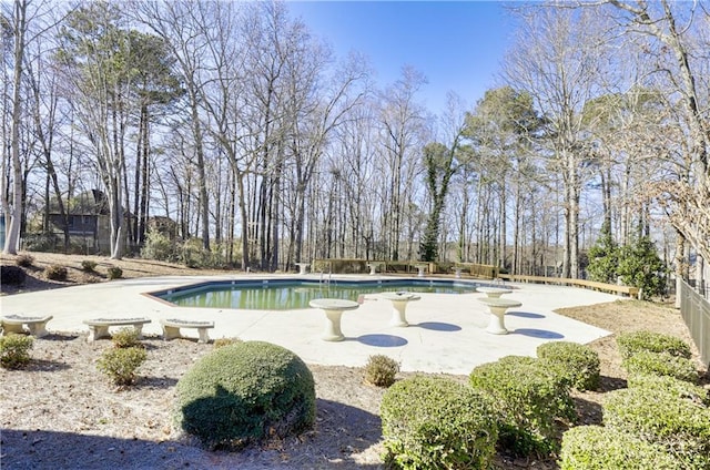 view of swimming pool featuring fence private yard