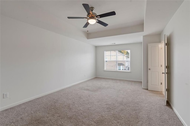 2231 Bedell Dr, Conyers, GA 30094 - spare room with light colored carpet, a tray ceiling, and a ceiling fan