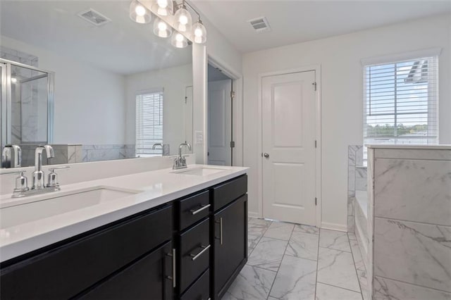 2231 Bedell Dr, Conyers, GA 30094 - full bath with marble look tile flooring, plenty of natural light, a bath, and double vanity