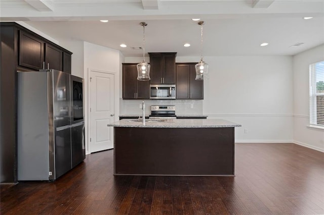 2231 Bedell Dr, Conyers, GA 30094 - kitchen featuring appliances with stainless steel finishes, dark brown cabinetry, dark wood-style flooring, tasteful backsplash, and recessed lighting