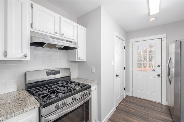 kitchen featuring white cabinets, light stone counters, stainless steel appliances, and dark wood-type flooring