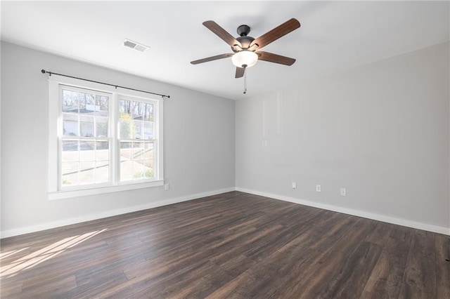 empty room with ceiling fan and dark hardwood / wood-style flooring