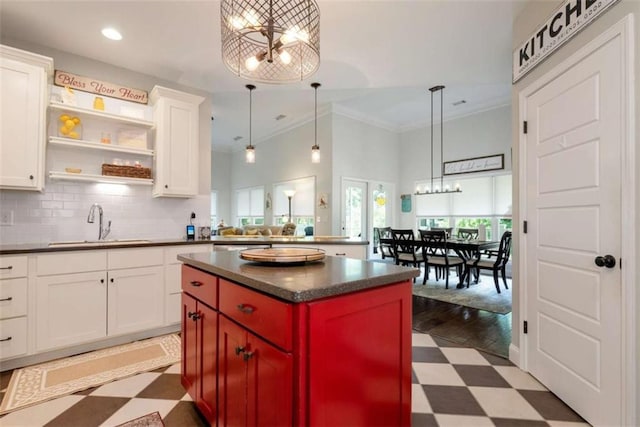 806 Skelton Rd, Hoschton, GA 30548 - kitchen featuring dark floors, dark countertops, a chandelier, backsplash, and white cabinetry