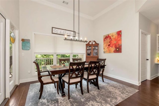 806 Skelton Rd, Hoschton, GA 30548 - dining area with a high ceiling, wood-type flooring, ornamental molding, and a chandelier