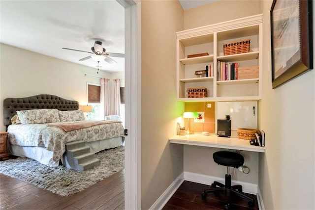 806 Skelton Rd, Hoschton, GA 30548 - bedroom with built in study area, dark wood finished floors, and a ceiling fan