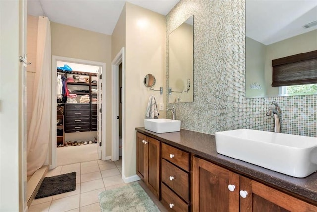 806 Skelton Rd, Hoschton, GA 30548 - bathroom featuring tile patterned flooring, double vanity, a walk in closet, and backsplash