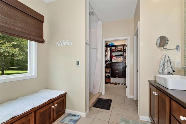 806 Skelton Rd, Hoschton, GA 30548 - bathroom with vanity, tile patterned floors, a stall shower, and a spacious closet