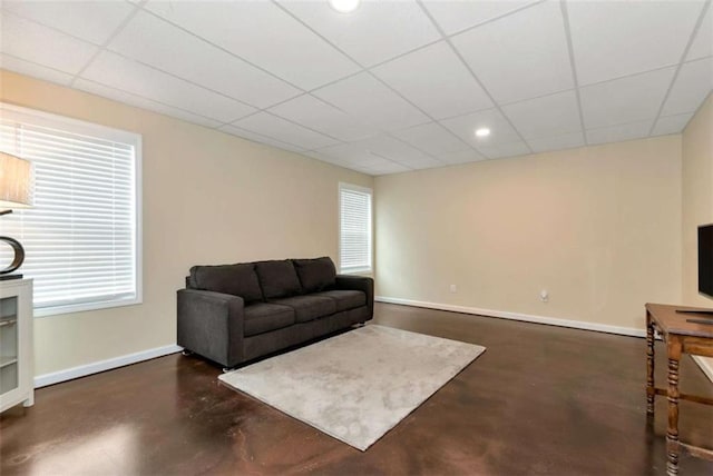 806 Skelton Rd, Hoschton, GA 30548 - living area featuring finished concrete flooring, a drop ceiling, recessed lighting, and plenty of natural light