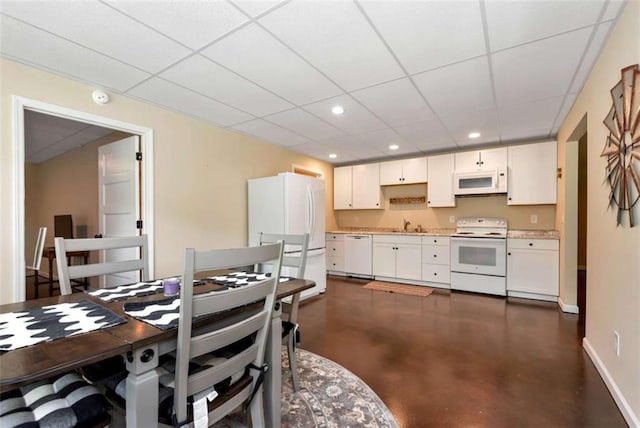 806 Skelton Rd, Hoschton, GA 30548 - dining space featuring concrete floors, a paneled ceiling, and recessed lighting
