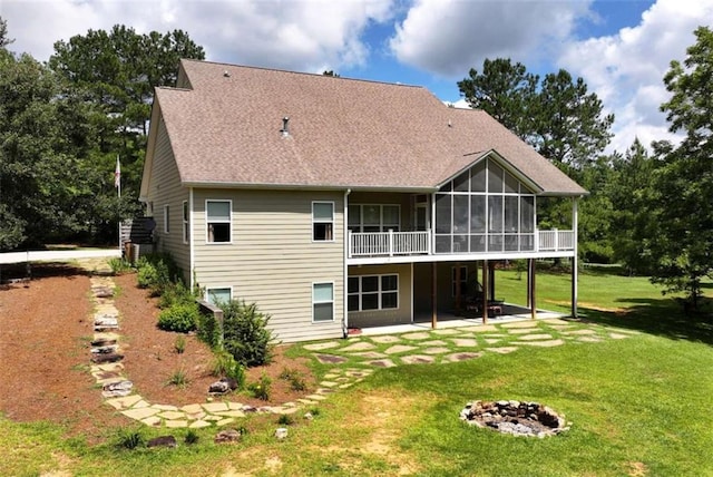 806 Skelton Rd, Hoschton, GA 30548 - back of house featuring a sunroom, an outdoor fire pit, a lawn, a patio area, and a shingled roof