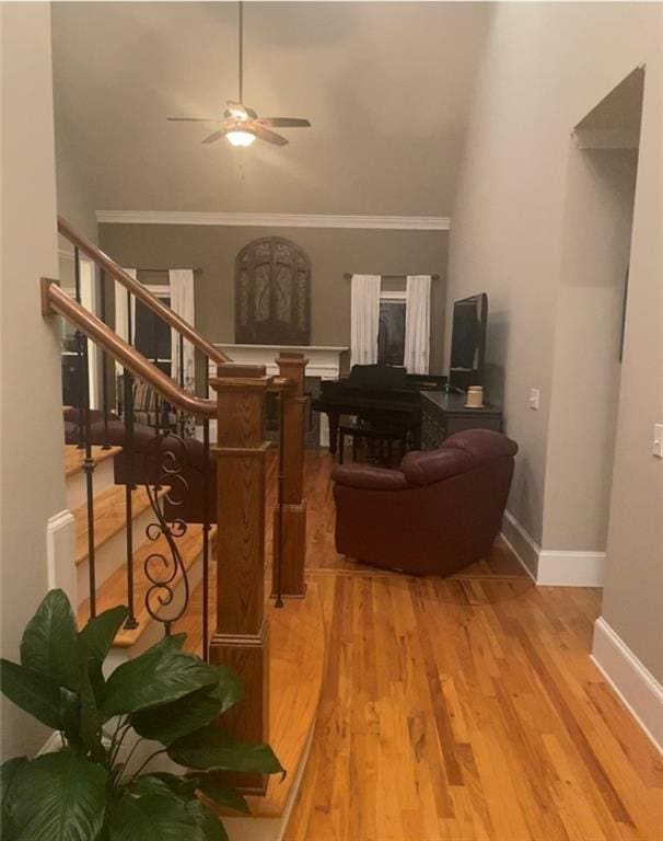 180 Hightower Lake Trl, Ball Ground, GA 30107 - living room featuring a ceiling fan, wood finished floors, stairway, and crown molding