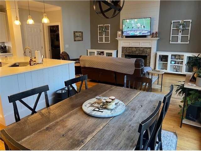 180 Hightower Lake Trl, Ball Ground, GA 30107 - dining room featuring light wood-style flooring and a fireplace