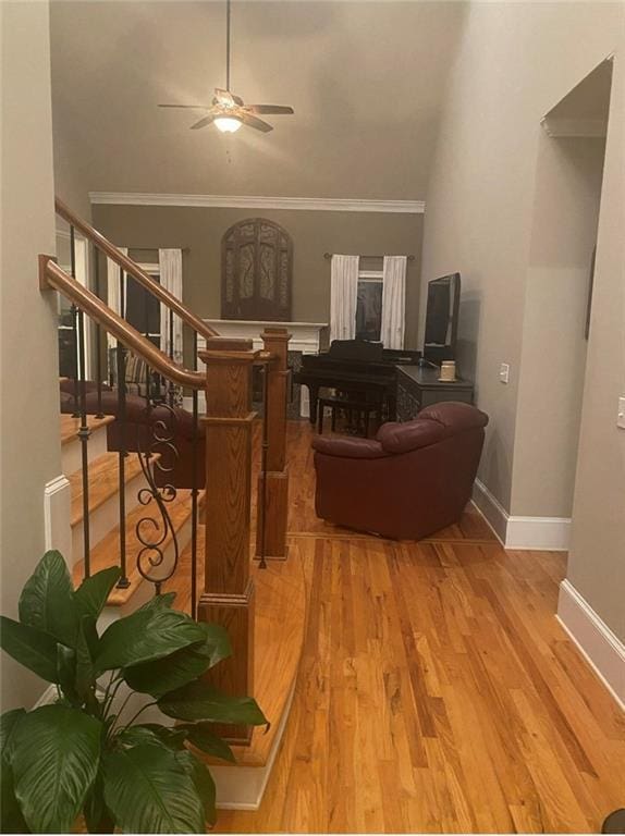 180 Hightower Lake Trl, Ball Ground, GA 30107 - living room featuring a ceiling fan, wood finished floors, ornamental molding, and stairway