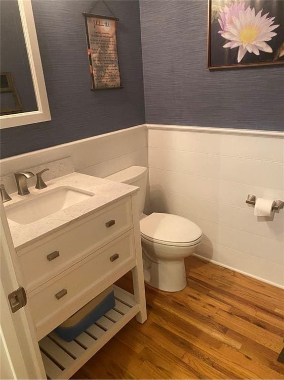 180 Hightower Lake Trl, Ball Ground, GA 30107 - half bath featuring wood finished floors, vanity, a wainscoted wall, and wallpapered walls