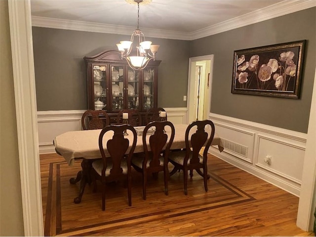 180 Hightower Lake Trl, Ball Ground, GA 30107 - dining room with a chandelier, wainscoting, crown molding, and wood finished floors