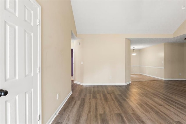 unfurnished room with dark wood-type flooring