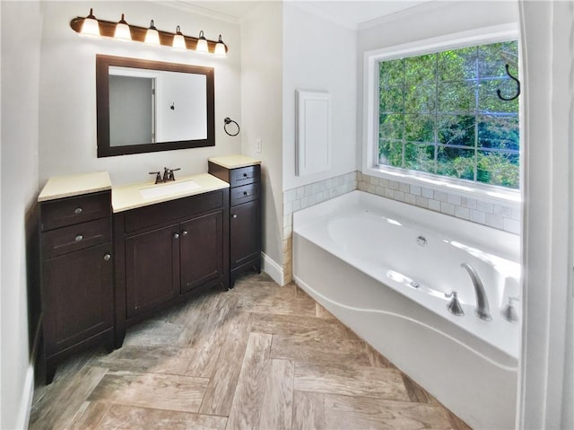 bathroom featuring a tub, crown molding, and vanity