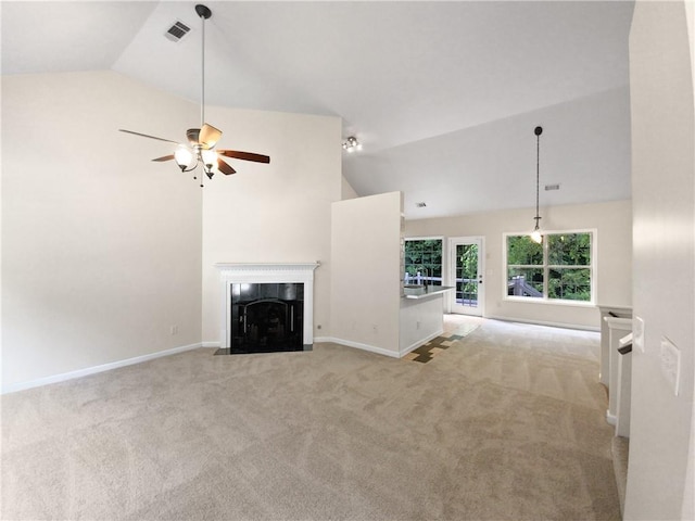 unfurnished living room with a tile fireplace, light carpet, and lofted ceiling