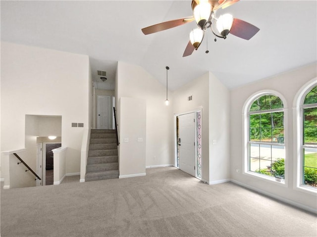 unfurnished living room featuring carpet flooring, ceiling fan, and vaulted ceiling