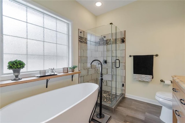 475 Brown Thrasher Ct, Alpharetta, GA 30009 - full bathroom featuring a freestanding bath, a stall shower, vanity, wood finished floors, and recessed lighting