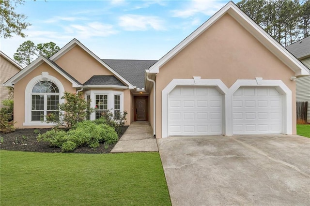 475 Brown Thrasher Ct, Alpharetta, GA 30009 - view of front of property featuring stucco siding, a garage, driveway, and a front yard