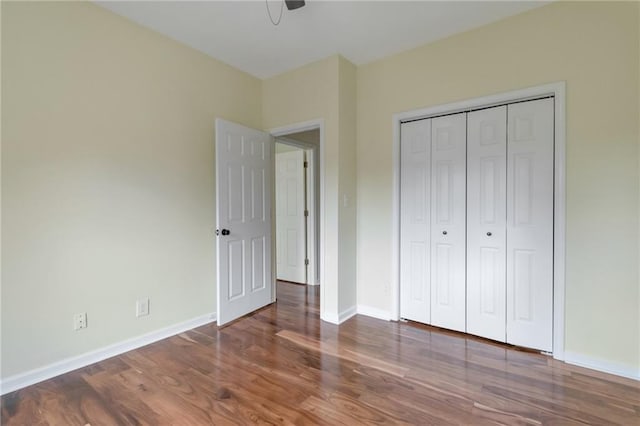 475 Brown Thrasher Ct, Alpharetta, GA 30009 - unfurnished bedroom featuring wood finished floors, a closet, and a ceiling fan