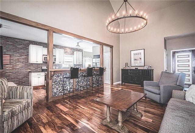 475 Brown Thrasher Ct, Alpharetta, GA 30009 - living area featuring dark wood-style floors, a chandelier, and a towering ceiling