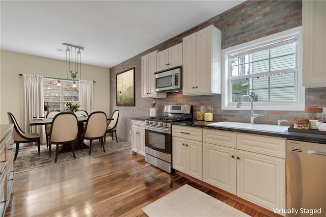 475 Brown Thrasher Ct, Alpharetta, GA 30009 - kitchen featuring appliances with stainless steel finishes, dark wood finished floors, dark countertops, and plenty of natural light