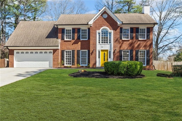 colonial inspired home featuring brick siding, fence, a garage, and a chimney